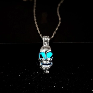 Glow in the dark skull pendant necklace in silver finish with luminous blue eyes