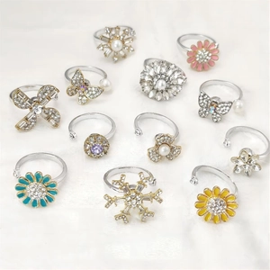 Rotating snowflake and flower rings with faux pearl inlays in adjustable silver gold bands