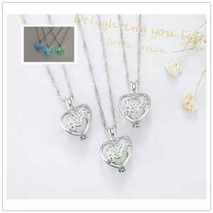 Luminous heart locket mother necklace showing blue green glow in the dark