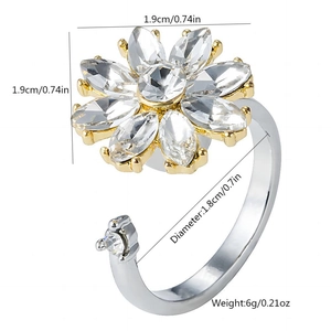Rotating snowflake flower ring with crystals and pearl details in gold and silver finish