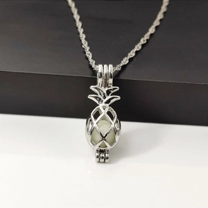 Luminous pineapple pendant necklace with hollow silver cage and glowing bead inside