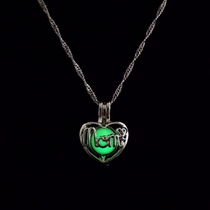 Detailed macro view of the openable heart-shaped glowing pendant necklace for mom