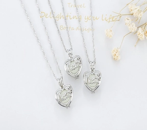 Detailed view of three silver mom heart locket necklaces with luminous glowing beads
