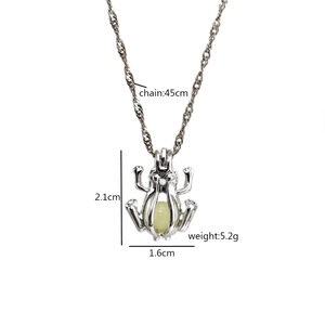 Cute luminous frog pendant necklace in silver hollow frame with light green glow bead