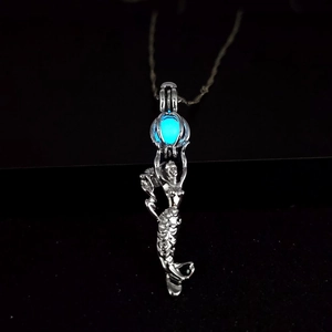 Luminous mermaid pendant necklace with a glowing blue bead and silver chain