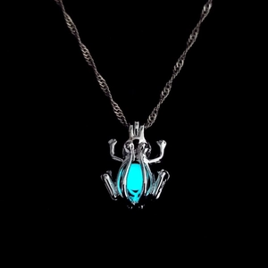 Luminous beetle pendant necklace with blue glow bead on a stylish silver wave chain