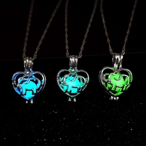 Luminous elephant heart necklace with blue and green glow in the dark pendant