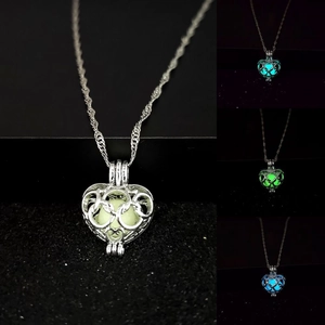 Detail showing hollow heart elephant pendant with glowing stones in various colors