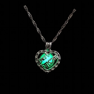 Glow-in-the-dark green bead inside a heart-shaped Best MOM pendant necklace in silver tone