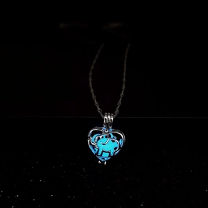 Glow in the dark heart pendant necklace featuring an elephant silhouette in blue neon light