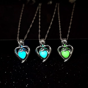 Luminous heart necklaces in blue, cyan, and green glowing in dark background
