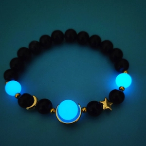 Luminous star and moon bracelet with glowing blue sandstone beads and black polished spheres