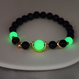 Luminous star and moon beaded bracelet with blue sandstone and glowing green crystals