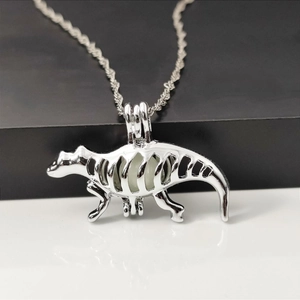 Luminous hollow dinosaur skeleton pendant necklace in silver metal with glow bead