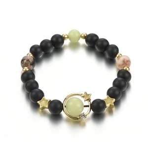 Luminous starry sky beaded bracelet with black matte beads and golden planetary ring charm