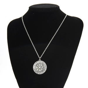 Detail of Viking Vegvisir compass pendant with runic alphabet on black velvet bust