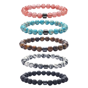 Detailed stack of 8mm natural stone beads including tiger eye and turquoise stretch bracelets