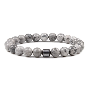 Macro shot of 8mm map stone beaded bracelet with polished black hematite cylinder