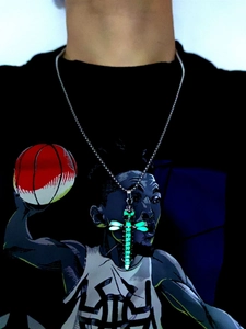 Luminous green glow skull cross pendant necklace with silver ball chain on a model