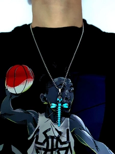 Close-up of a dragonfly necklace pendant with glowing blue luminous wings and silver finish