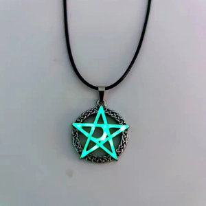 Detailed view of Celtic pentagram pendant with glowing turquoise luminous coating