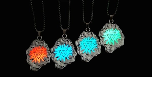 Macro detail of Nordic Viking pendants showing luminous geometric totems and lava texture