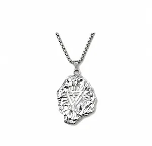 Detail of silver Viking pendant with irregular lava texture and geometric symbol