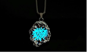 Luminous Viking Valknut necklace with glowing blue stone pendant in dark background