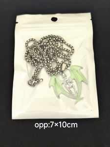 Gothic skull skeleton pendant with green bat wings in transparent OPP packaging
