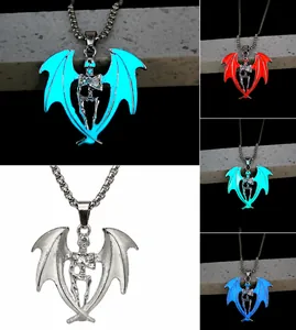 Luminous gothic skull pendant with bat wings showing four fluorescent glow colors in the dark