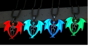 Luminous gothic skull pendants with bat wings glowing in red, blue, and green light