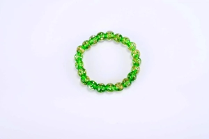 Detail view of glowing green glass beads with shimmering gold foil interior craftsmanship