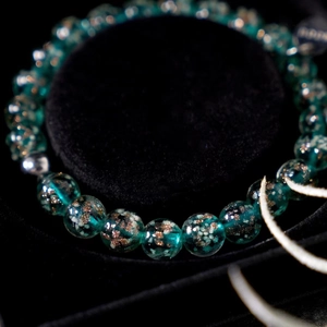 Handcrafted luminous glass bead bracelet with gold foil and starry night effect for healing