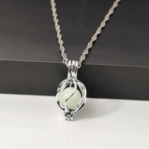 Luminous planet pendant necklace with glowing bead on a silver twisted chain