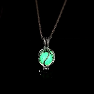 Luminous green planet pendant necklace glowing in the dark with a silver chain link