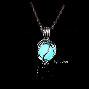Detailed close-up of a cage pendant glowing in light blue with silver twist chain