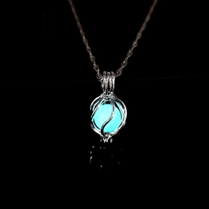 Luminous planet necklace featuring blue glowing bead inside silver hollow cage pendant