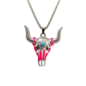 Macro shot of silver bull skull pendant featuring neon pink accents and blue turquoise stone