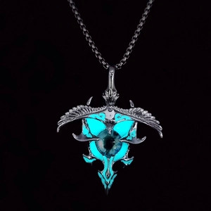 Macro detail of punk eagle pendant with glowing turquoise eye and silver wings