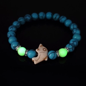 Luminous turquoise beaded bracelet with dolphin charm and blue textured round stones