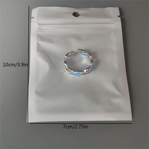 Detailed view of glow-in-the-dark leaf ring with blue enamel and packaging dimensions