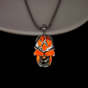 Punk style glowing skull pendant necklace with orange accents and silver beaded chain