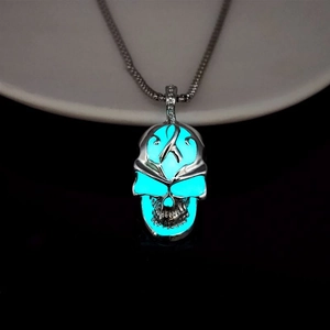 Macro shot of glow-in-the-dark skull pendant necklace with blue luminous effect