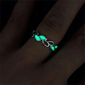 Adjustable silver leaf branch ring with green luminous glow in the dark effect on finger