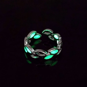 Detailed close-up of adjustable leaf ring glowing in dark with green luminescent filling