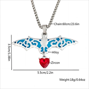Gothic luminous bat necklace with hollow design and red heart crystal pendant on white backdrop