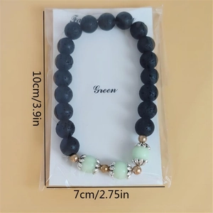 Detailed size view of black lava stone bracelet with luminous beads and silver lotus spacer