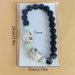 Bracelet tête de mort Halloween avec pierre de lave, turquoise et perles lumineuses