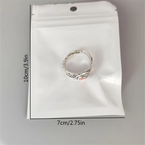 Detail view of vintage luminous ring with engraved patterns and red accent on the band