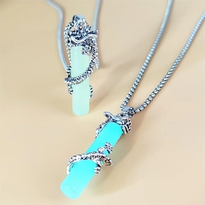 Detailed view of silver dragon wrapped cylinder pendants in green and blue colors